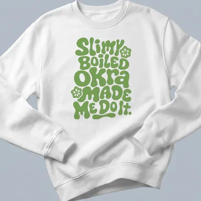 Playful typography t-shirt featuring okra-themed humor in green bubble letters — printed on a unisex sweatshirt