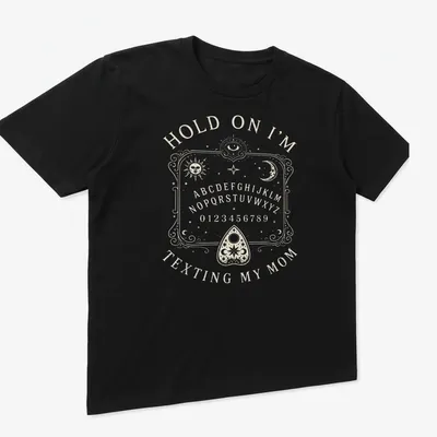 Vintage Ouija board design with humorous text about texting mom. — printed on a unisex t-shirt (angled view)