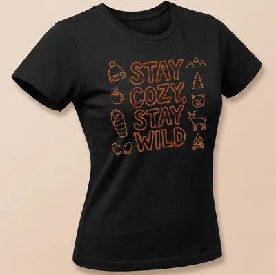Doodle art shirt with camping elements and the text Stay Cozy, Stay Wild in bright orange and white — printed on a women's shirt
