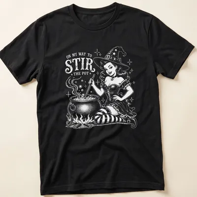 Retro witch pinup t-shirt with a playful slogan and colorful illustration.