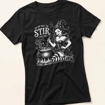 Retro witch pinup t-shirt with a playful slogan and colorful illustration. — printed on a women's shirt