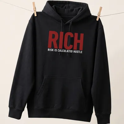Bold typography t-shirt featuring the phrase 'Rich Risk Is Calculated Hustle' in maroon and white. — printed on a unisex hoodie