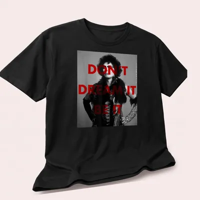 Dr. Frank t-shirt with the inspirational quote Don't Dream It Be It in red and black. — printed on a unisex t-shirt (angled view)