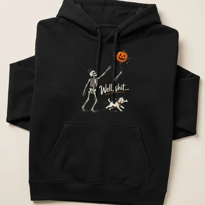 Playful cartoon skeleton dog chasing a pumpkin balloon with humorous text — printed on a unisex hoodie