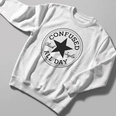 Circular badge with the text Confused Chuck Taylor All Day and a star graphic — printed on a unisex sweatshirt