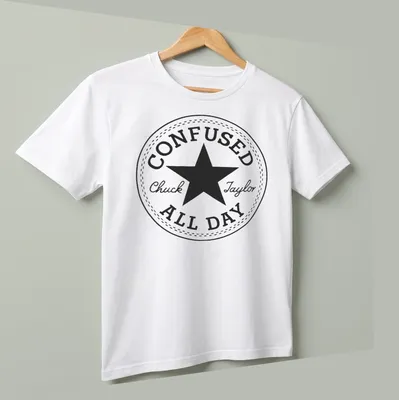Circular badge with the text Confused Chuck Taylor All Day and a star graphic — printed on a unisex t-shirt (angled view)