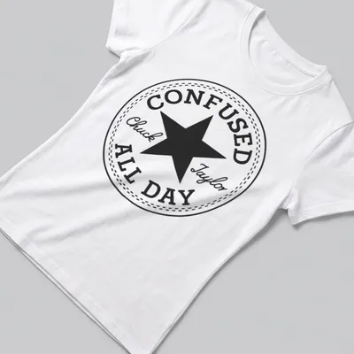 Circular badge with the text Confused Chuck Taylor All Day and a star graphic — printed on a women's shirt
