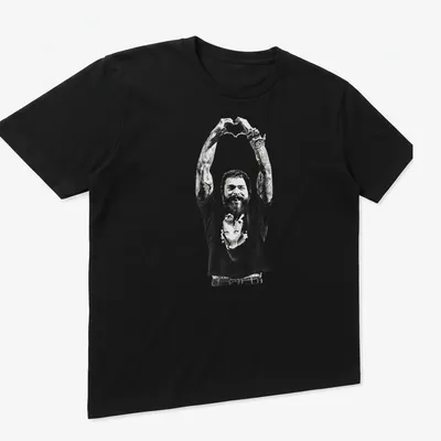 Black and white illustration of a tattoo artist making heart hands gesture — printed on a unisex t-shirt (angled view)