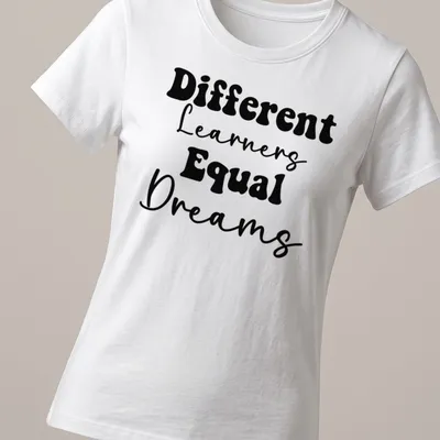 Bold typography Teacher shirt with the phrase Different Learners Equal Dreams printed in black. — printed on a women's shirt