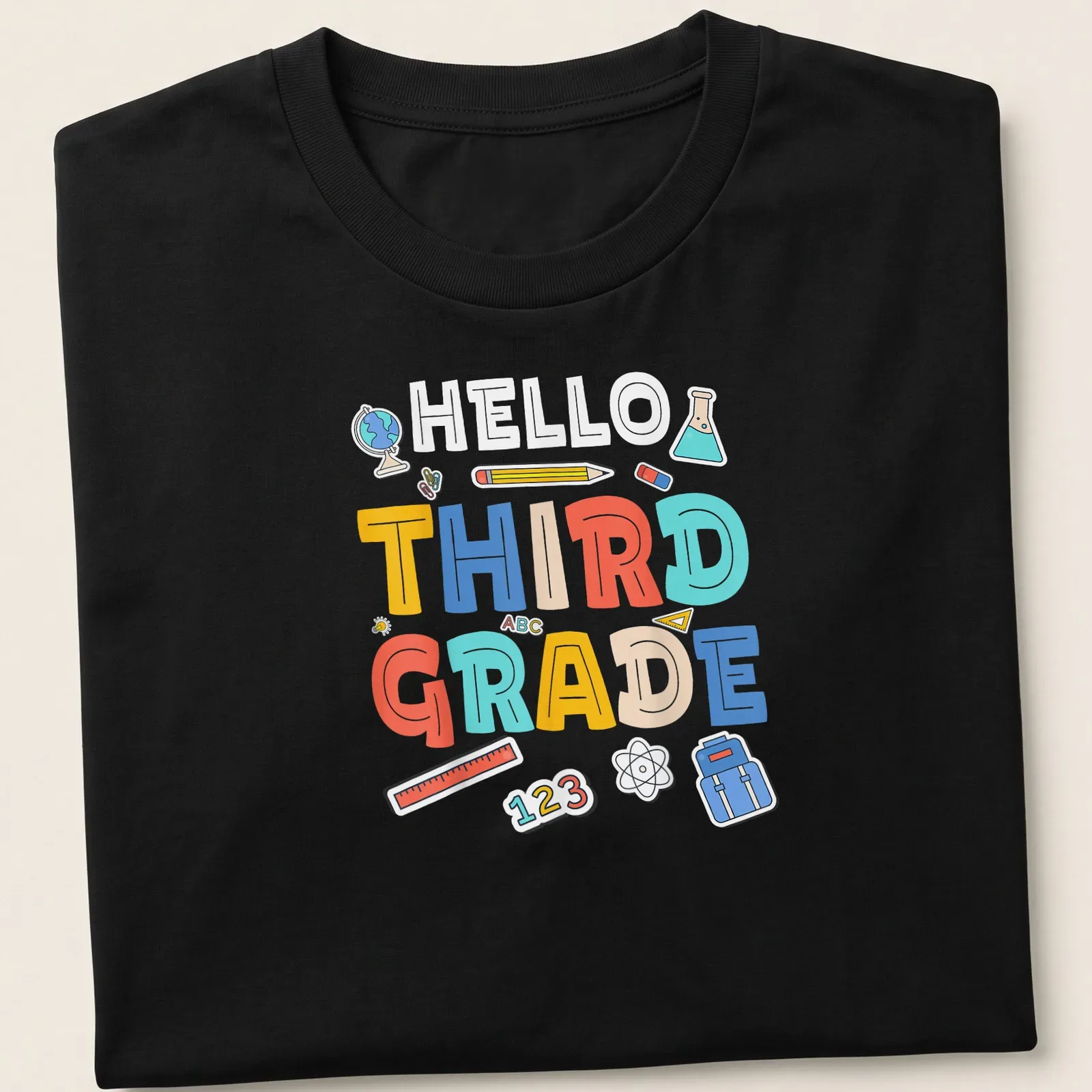 Colorful cartoon t-shirt with 'HELLO THIRD GRADE' and school supplies illustrations. — printed on a unisex t-shirt