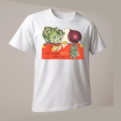 Vintage illustration of smiling beets and broccoli with the text 'My Heart Beets For You!' — printed on a unisex t-shirt (angled view)