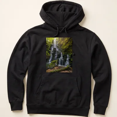 Photographic print of a waterfall surrounded by lush greenery in earthy tones — printed on a unisex hoodie