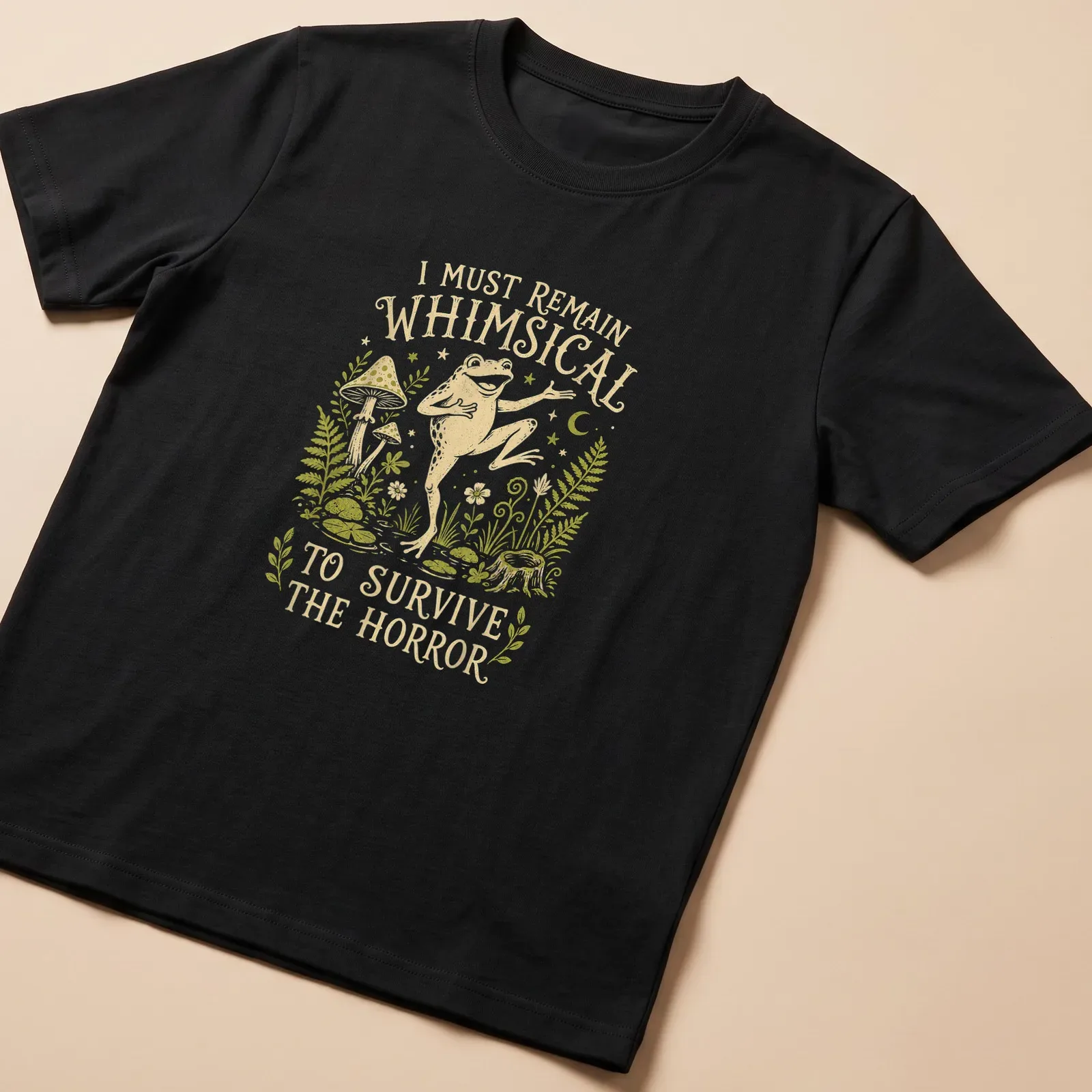 Whimsical illustration of a frog with the text 'I Must Remain Whimsical To Survive The Horror' — printed on a unisex t-shirt