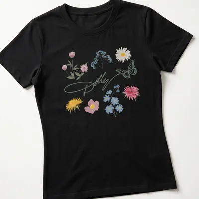 Illustrative T-shirt featuring the text 'Dolly' with wildflowers and a butterfly — printed on a women's shirt