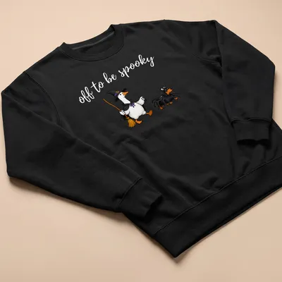 Cartoon of a witch goose walking a spider dachshund with spooky text — printed on a unisex sweatshirt