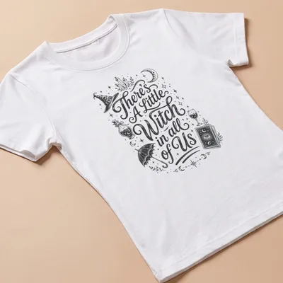 Vintage hand-drawn t-shirt featuring 'There's A Little Witch in all of Us' with witchcraft elements — printed on a women's shirt