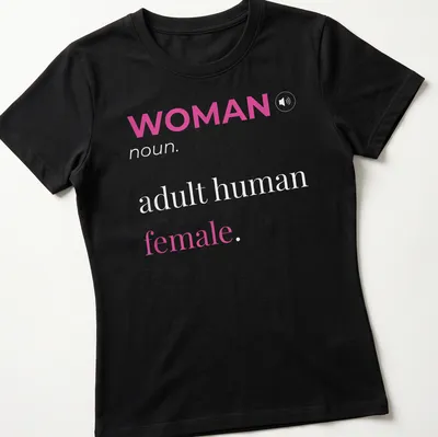 Modern typography t-shirt featuring 'WOMAN noun. adult human female.' in pink and white. — printed on a women's shirt