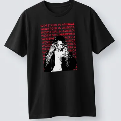 Bold graphic tee featuring the text 'WOR$T GIRL IN AMERICA' with an illustration of a woman with curly hair.